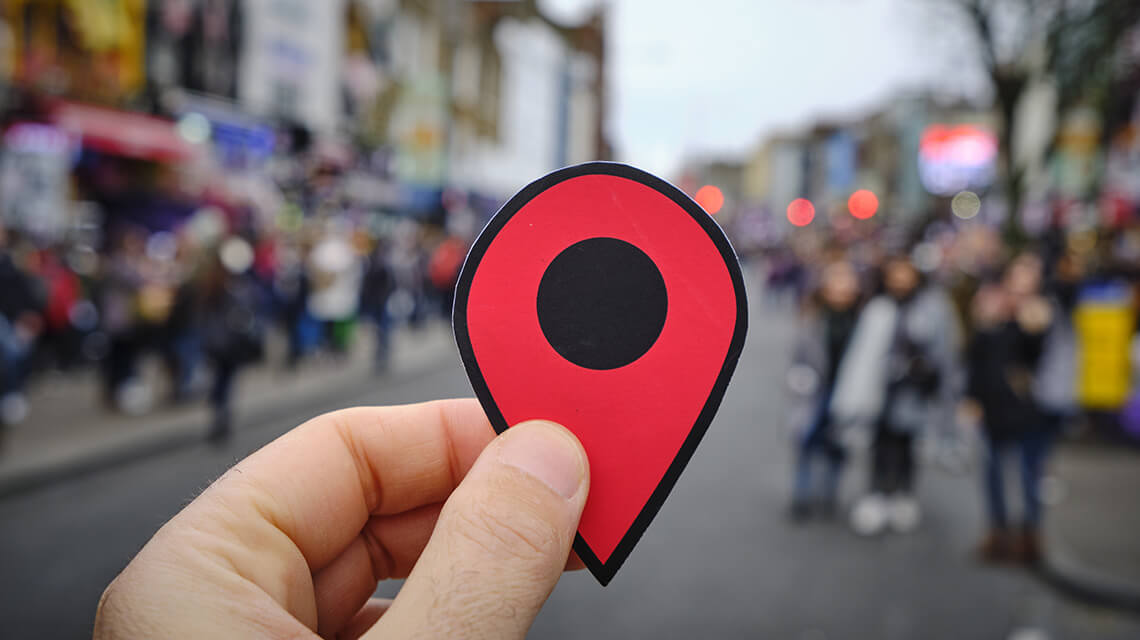 A location pin on a busy street.
