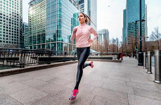 A lady running in London Docklands