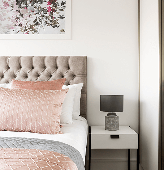 A close-up of a bed in a Newacre House show apartment by Galliard Homes.