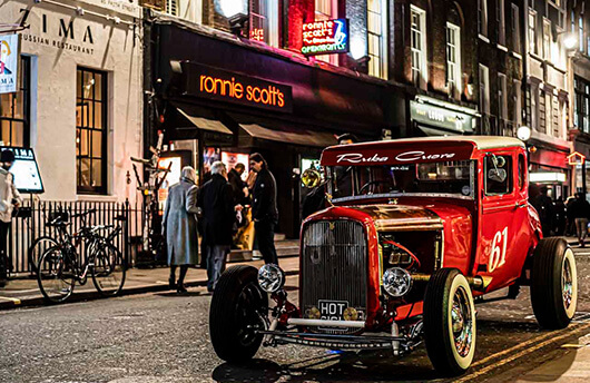 An old-fashioned car parked outside Ronnie Scott's Jazz Club in Soho