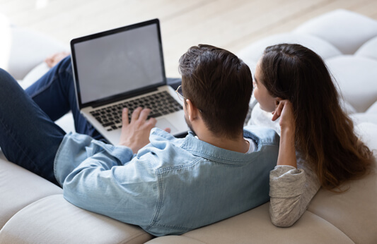 Couple browsing Buyer Guides by Galliard Homes