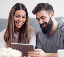 Couple on their tablet using Galliard's online tool to calculate Stamp Duty