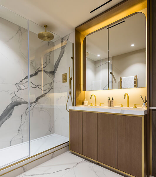 A luxurious marble and gold shower room at TCRW SOHO