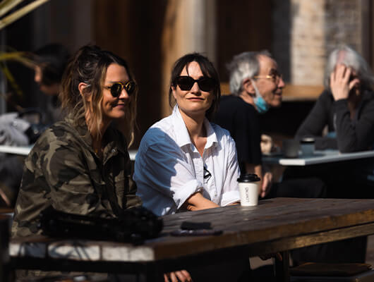 People sitting outside an independent cafe in Deptford.