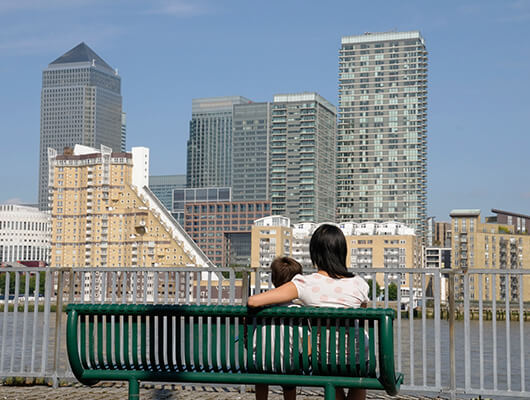 A mother and child sitting on a bench in South London.