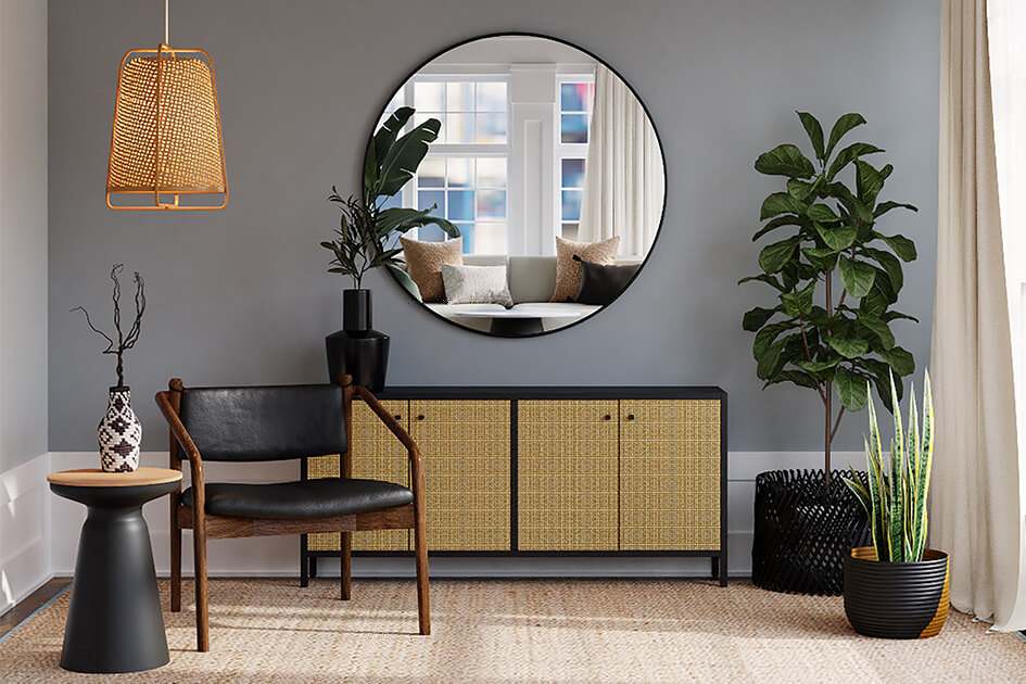 A stylish living room with a plant, leather chair and textured console table.