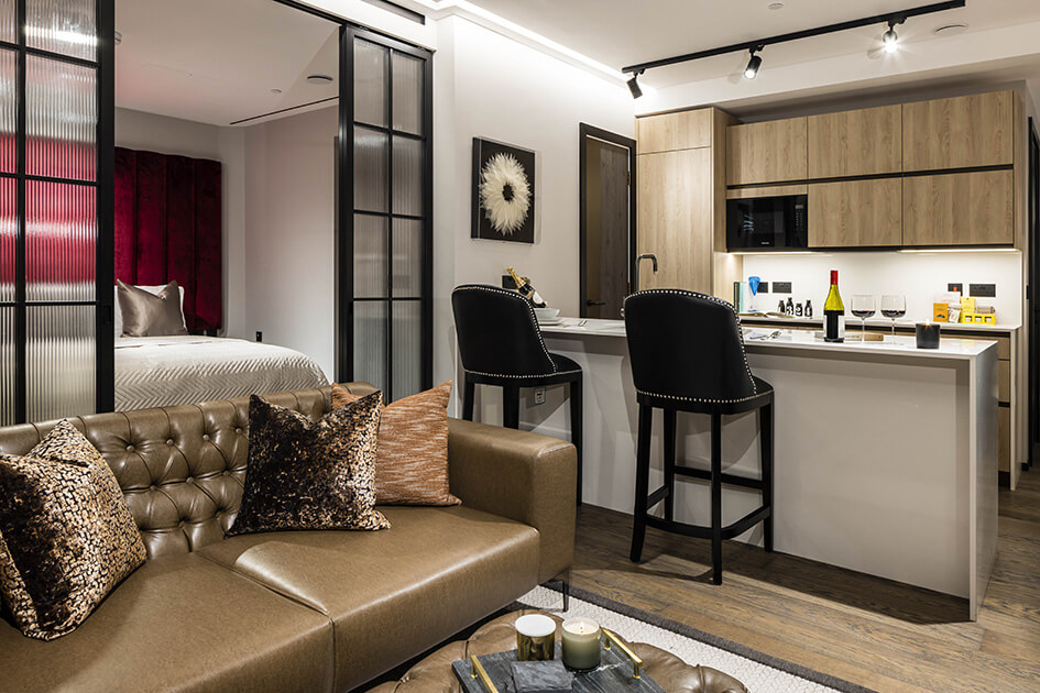 A living and kitchen area with a breakfast bar at a show apartment at The Stage in Shoreditch