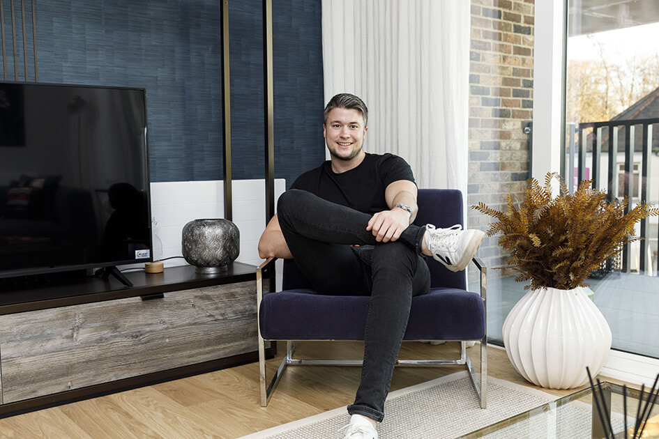 First-time buyer sitting in his new lounge at Wimbleon Grounds.