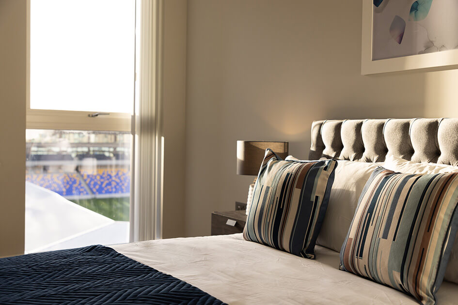 A bed in a Wimbledon Grounds show apartment that overlooks the pitch at AFC Wimbledon.