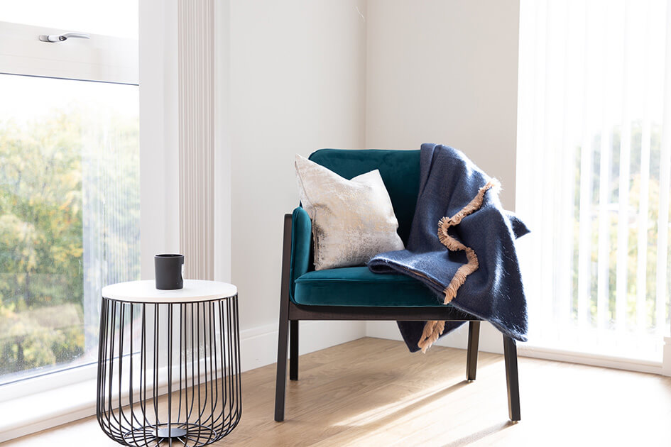 A chair and blanket in a home office at Wimbledon Grounds.