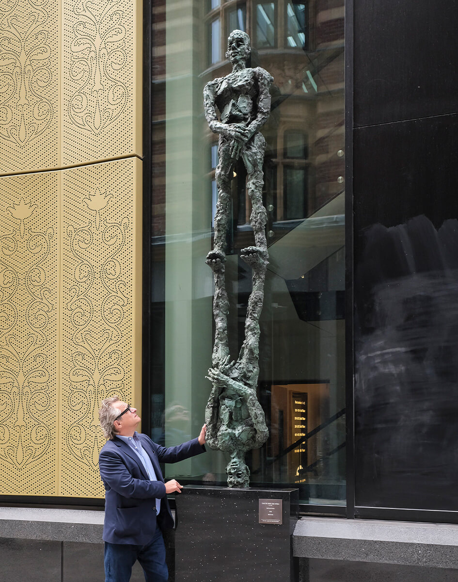 David Breuer-Weil standing proudly with his art, "Reflection"