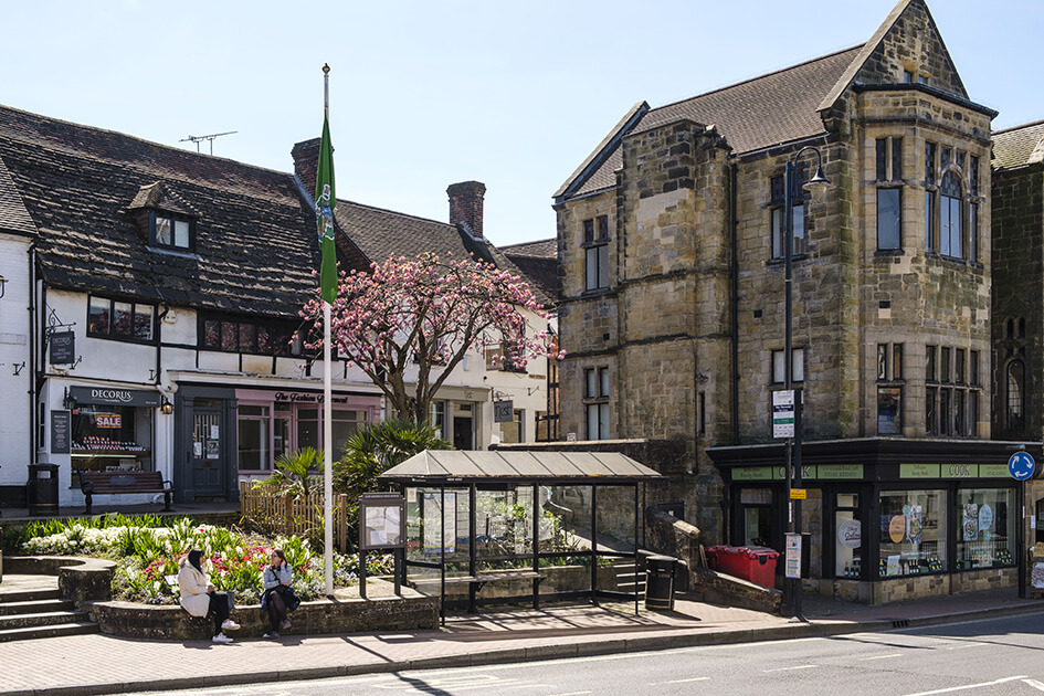 Shops and a bus stop on East Grinstead high street.