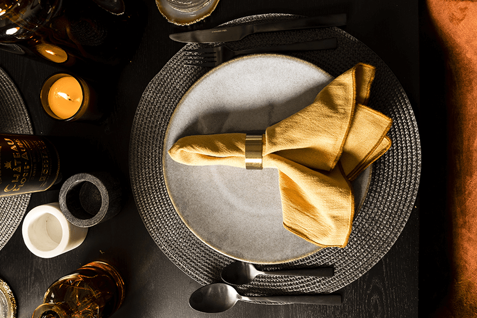 Napkin, candle and platemats on an autumn tablescape at TCRW SOHO by Galliard Homes