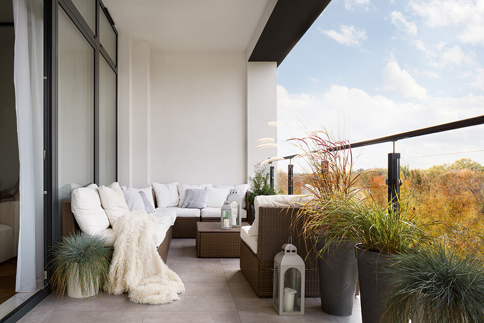 A balcony with a sofa and plants.