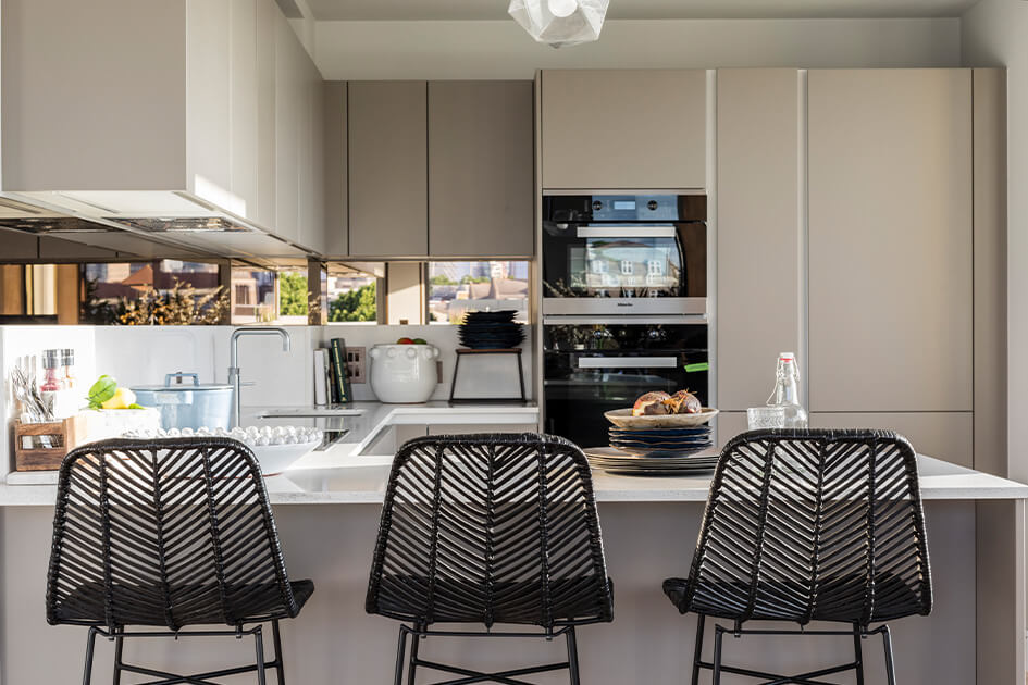 A kitchen area and breakfast bar at a Galliard Homes apartment.