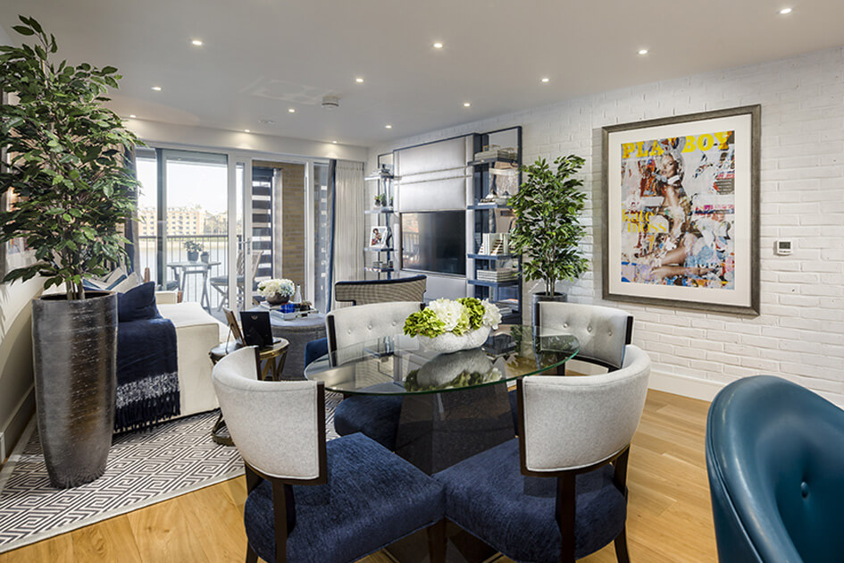 The living and dining area with a balcony overlooking the River Thames at a show apartment at Wapping Riverside.
