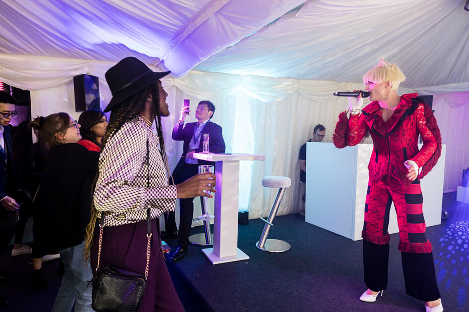 Drag artist, Envy The Queen entertaining guests,