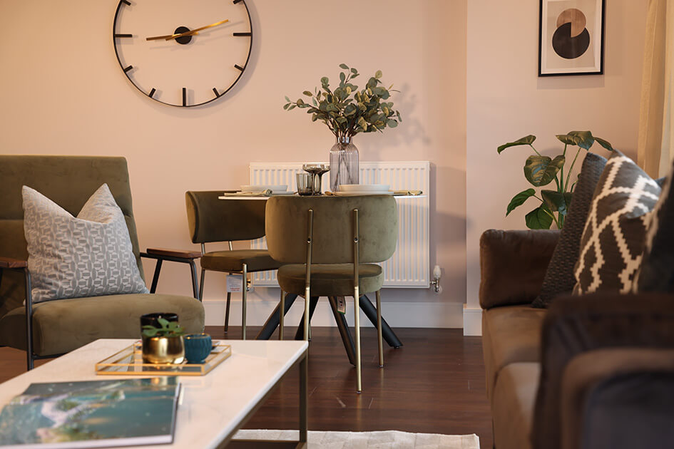 A sofa and dining table in a stylish apartment at Orchard Wharf in London Docklands.