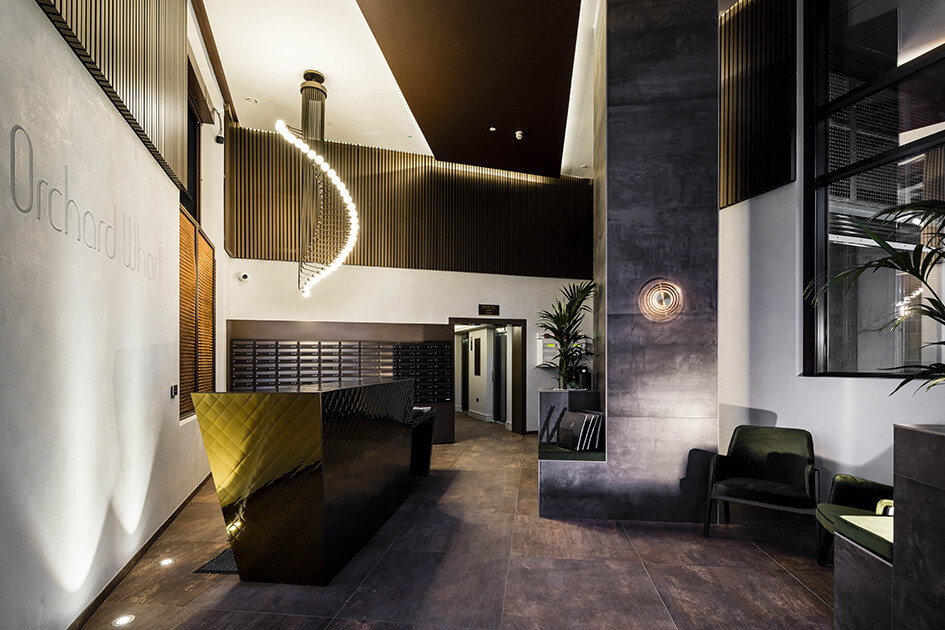 The decadent lobby and concierge area at Orchard Wharf with a desk and seating.