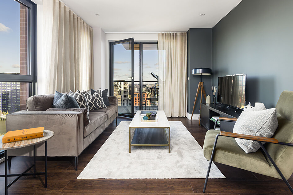 A bright living area with views overlooking London Docklands at Orchard Wharf.