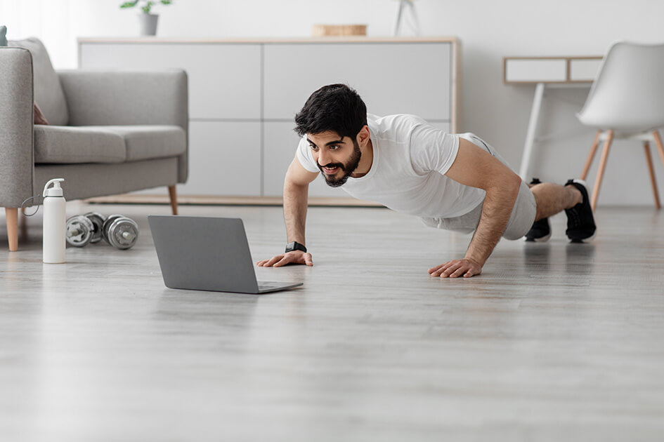 Man doing press-ups in his living room