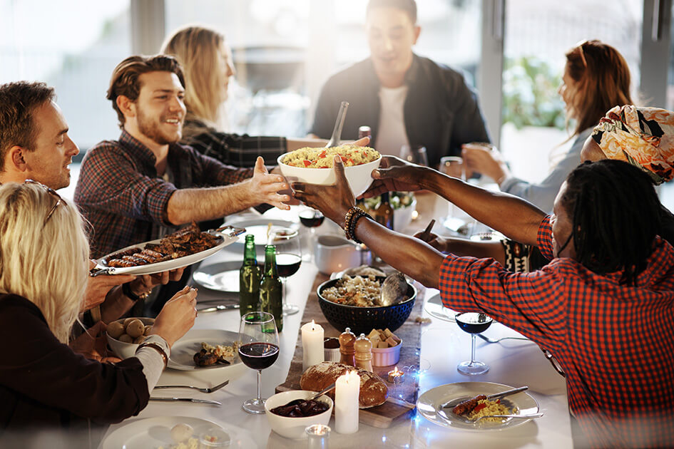 A group of people sitting round a dinner table.