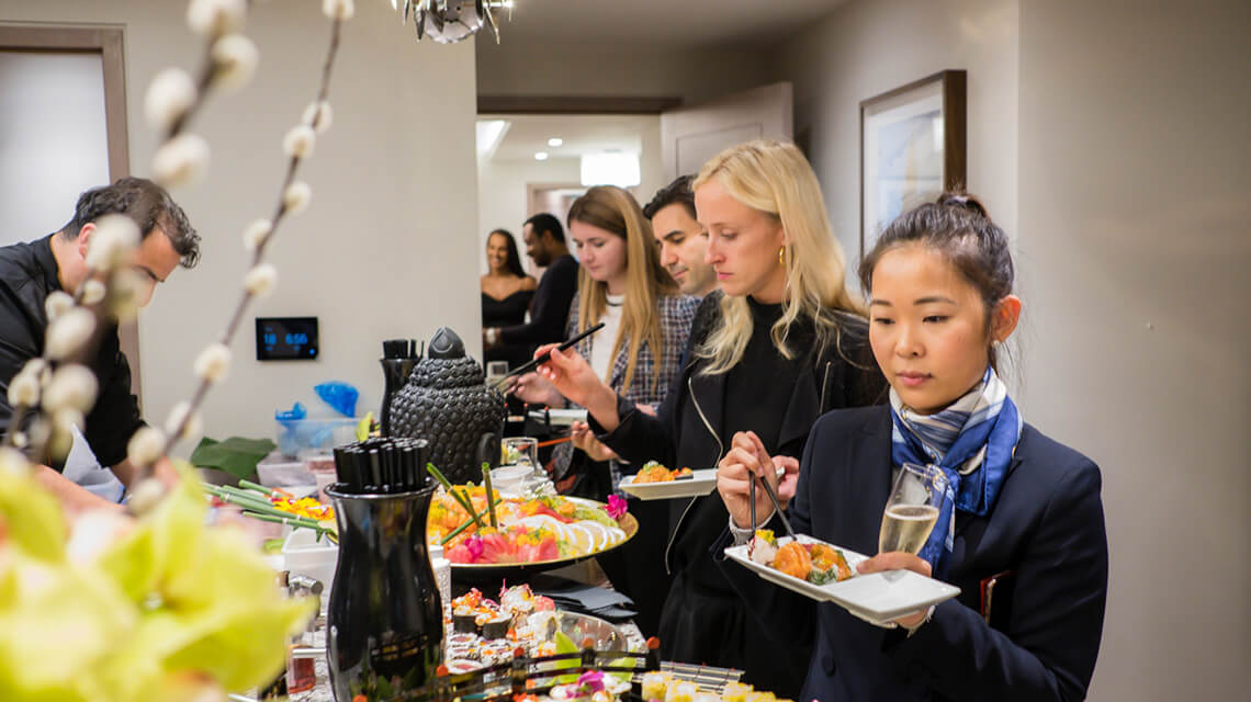 Attendees of the HedgeBrunch eating sushi