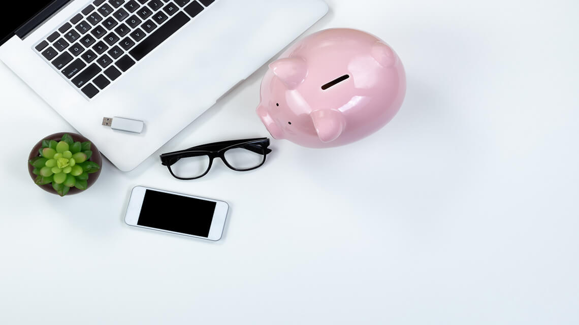 Laptop, piggybank, iPhone and glasses.