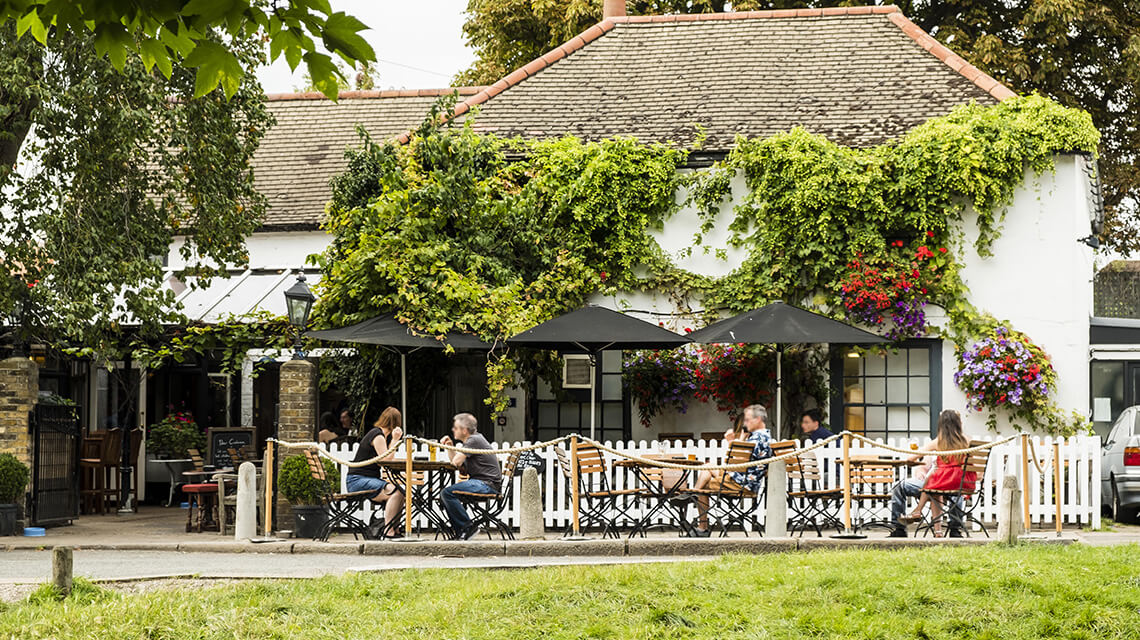 People dining outside a restaurant in Wimbledon Village.