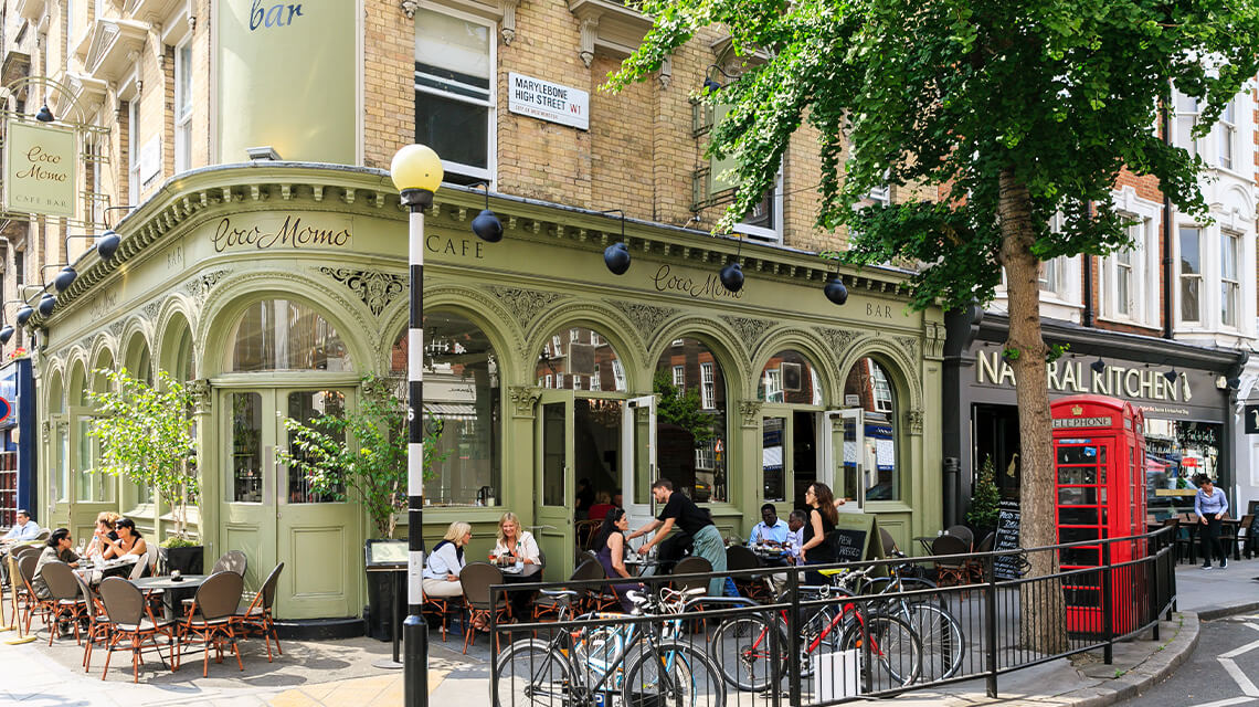 People sitting outside Coco Momo cafe on Marylebone High Street