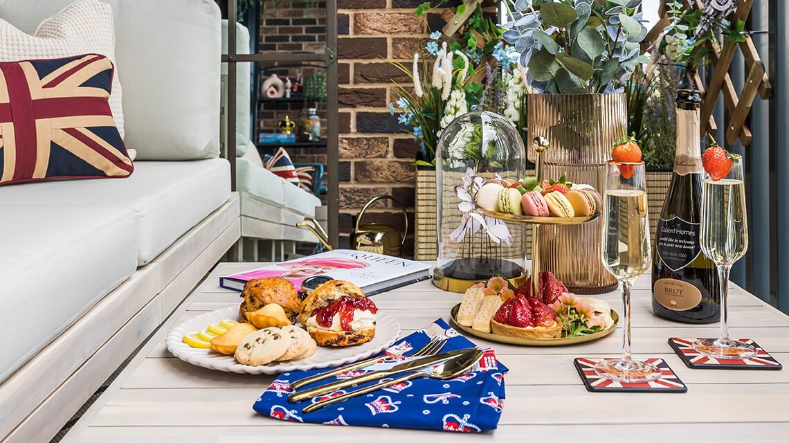 A royal themed table setting with scones and prosecco.