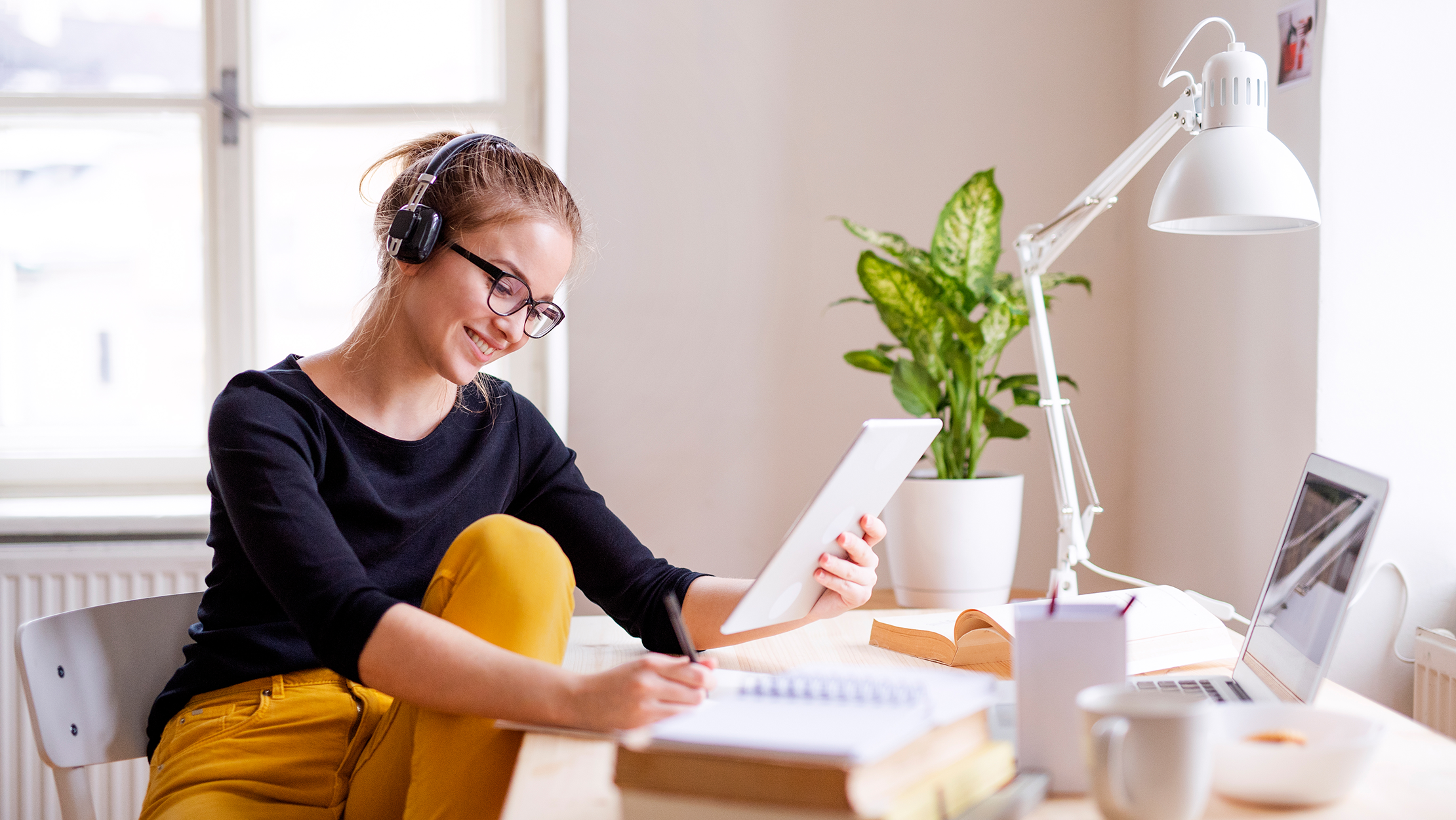 Woman listens to music while she works from home, Galliard Homes