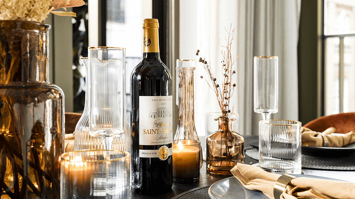 An autumnal table with candles, wine and glassware at TCRW SOHO by Galliard Homes