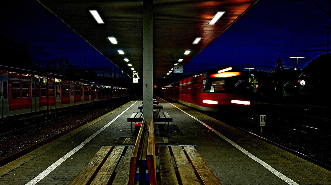 A platform at a tube station at night.