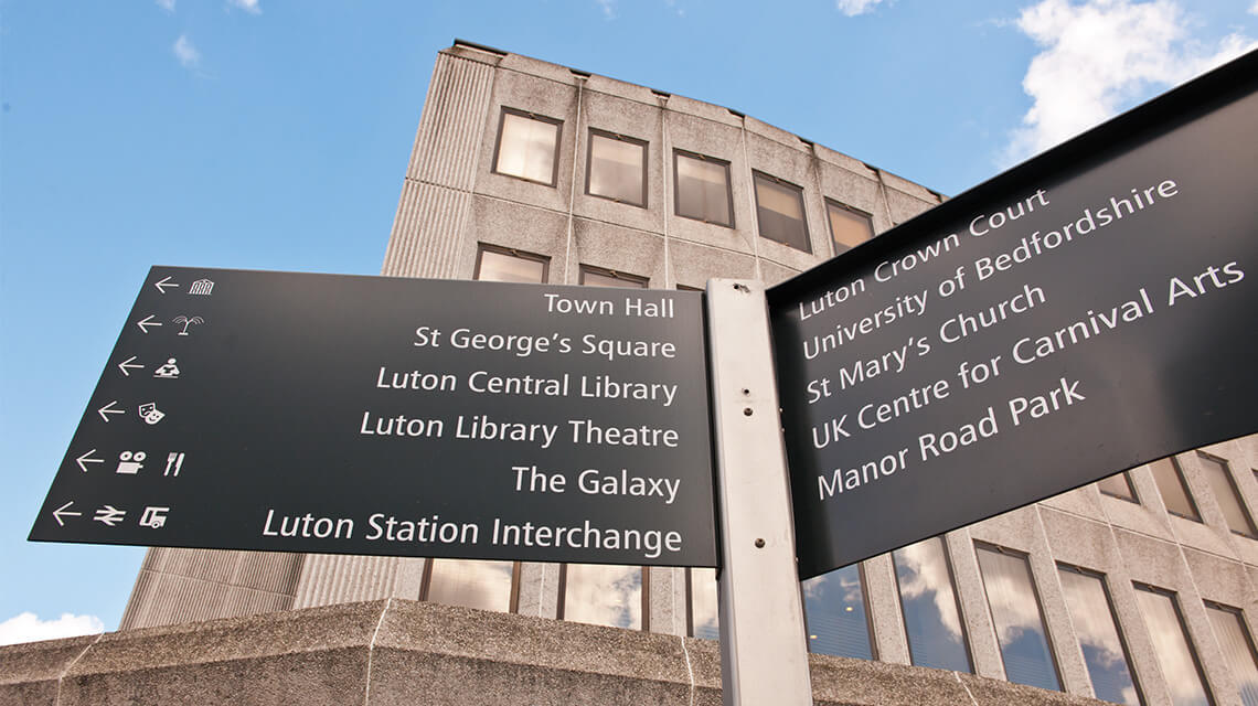 A direction sign in Luton, a good place for buy-to-let investment.