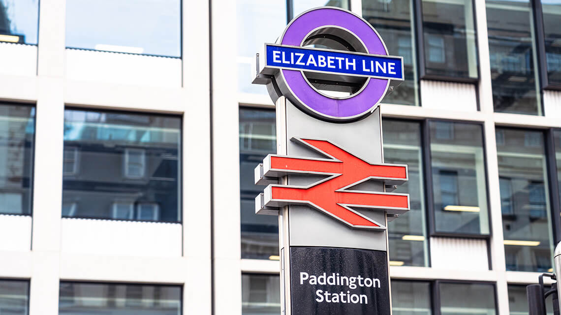 Sign outside Paddington station with Elizabeth line logo.