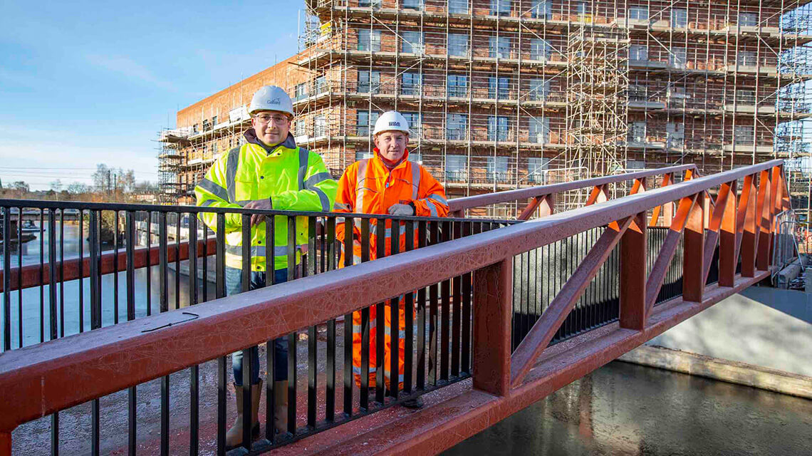 Jonathan Wilson, design manager at Galliard Homes, with Richard Hinckley, sales director at Beaver Bridges, on the newly installed bridge at Soho Wharf, Birmingham.