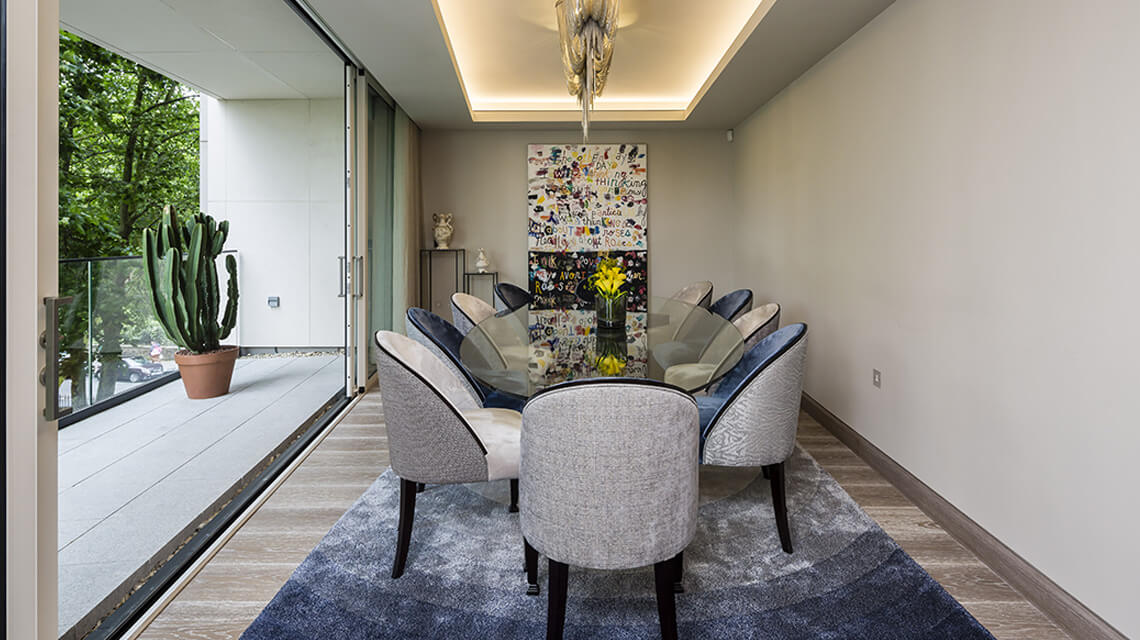 A dining area and balcony at an apartment at The Chilterns by Galliard Homes.