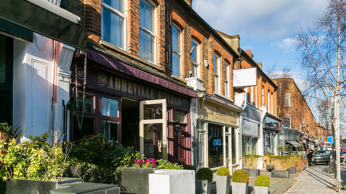 Shops and restaurants on a street in Clapham.