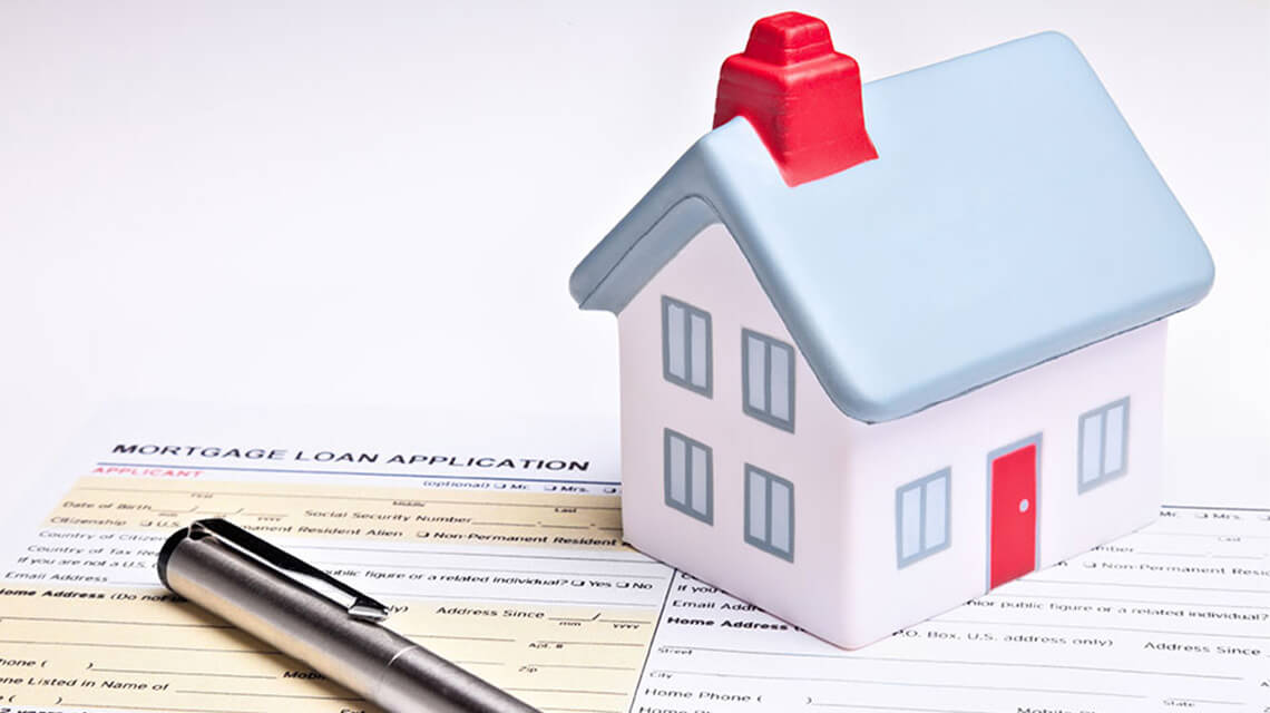 House model on a mortgage application form, first time buyer's guide to first home mortgages.