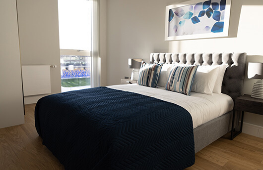 A bedroom at Wimbledon Grounds overlooking the AFC Wimbledon Stadium.