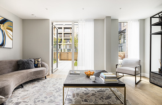 A living area and garden at a show maisonette at Wimbledon Grounds by Galliard Homes