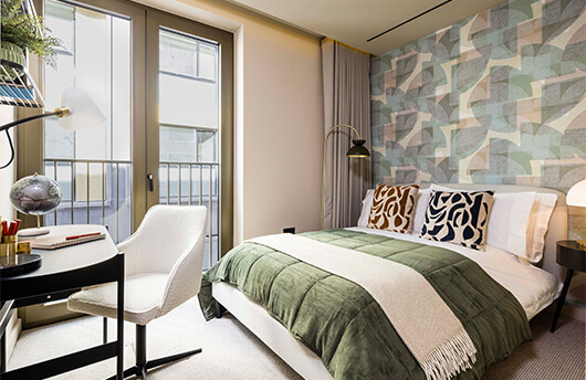A stylish bedroom with a balcony at a TCRW SOHO apartment.