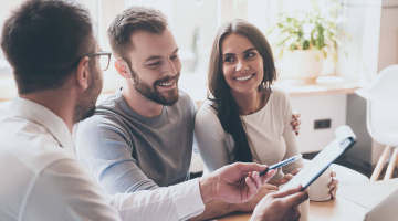 First-time buyers speaking to a mortgage advisor