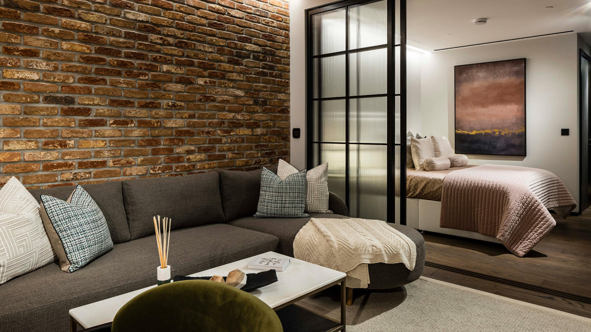 Open-plan living and bedroom area in a studio suite at The Stage, ©Galliard Homes.