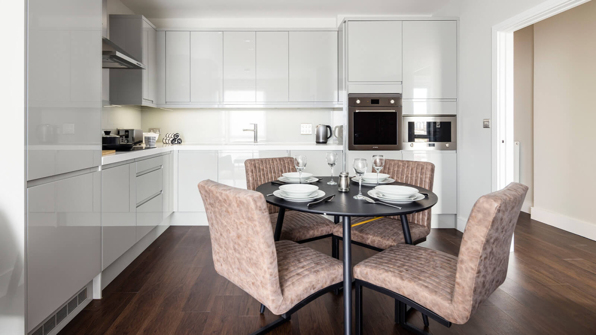 Open-plan kitchen and dining area at an Orchard Wharf apartment, ©Galliard Homes.
