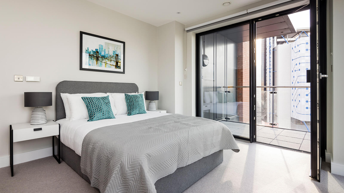 Bedroom and balcony at an Orchard Wharf apartment, ©Galliard Homes.
