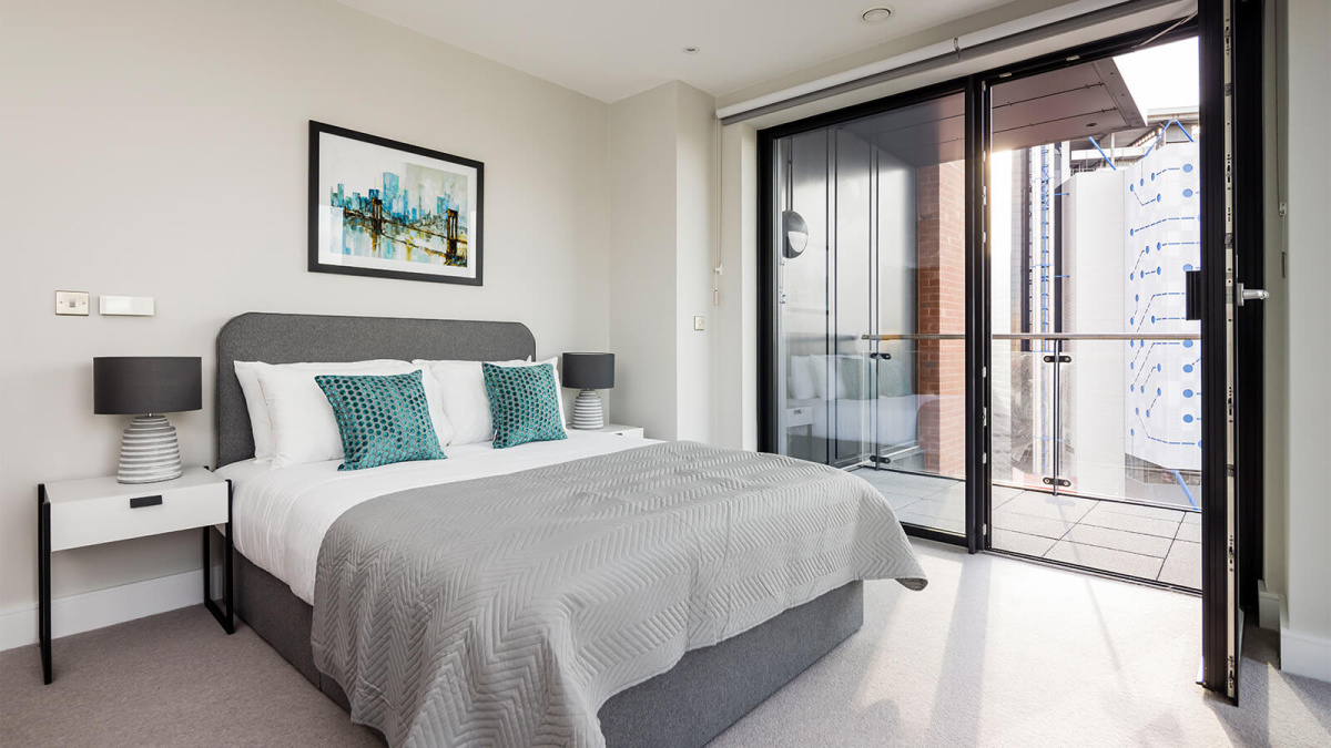 Bedroom and balcony at an Orchard Wharf apartment, ©Galliard Homes.
