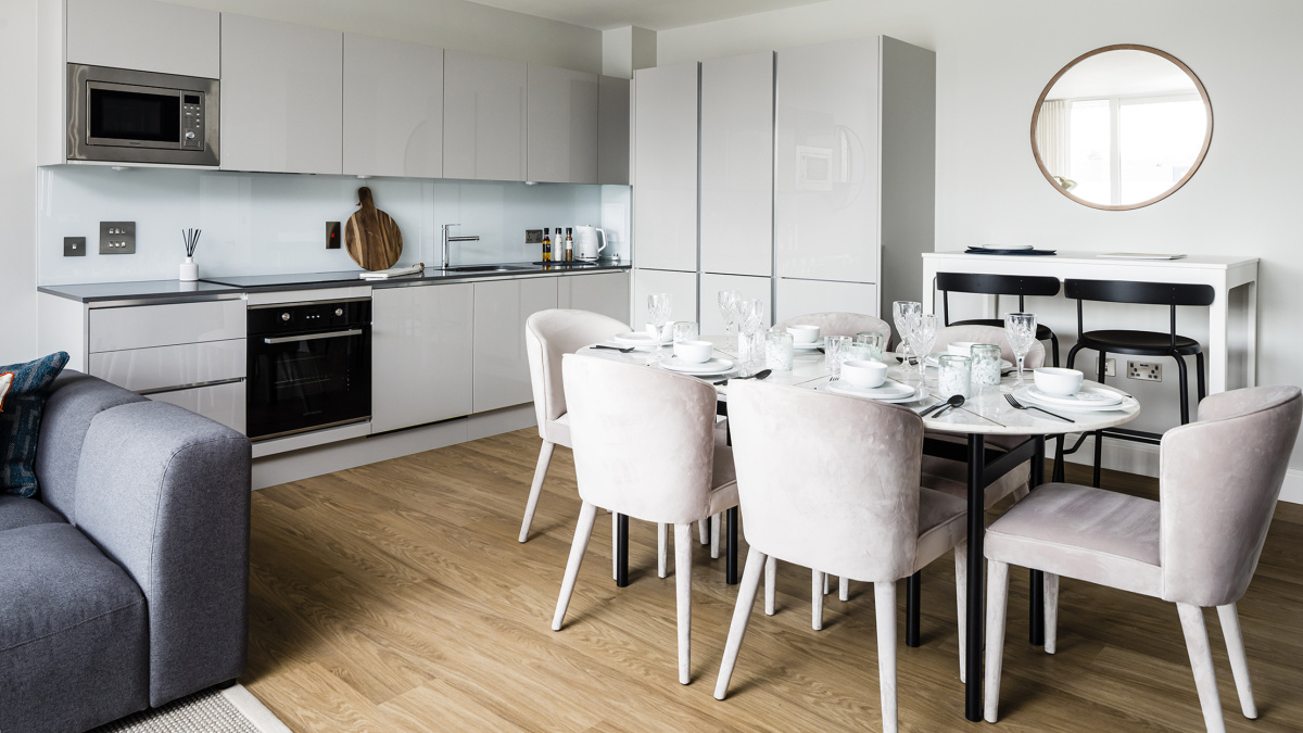 Open-plan kitchen, living area at a Wimbledon Grounds apartment, ©Galliard Homes.