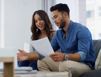 First-time buyers looking at a laptop.